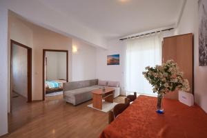 a living room with a couch and a table at Calypso in Kaštela