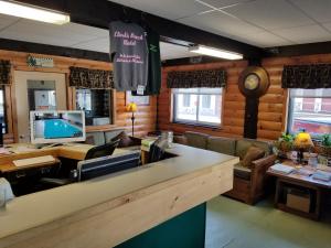 a restaurant with a bar with a tv and a counter at Clark's Beach Motel in Old Forge