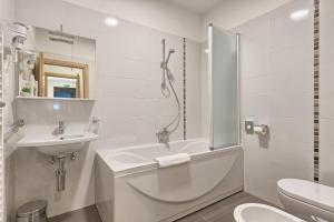 a bathroom with a tub and a sink and a toilet at Adriatic Apartments Fažana in Fažana +76 photos