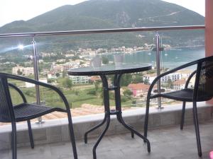 a table and two chairs on a balcony with a view at Katerina Lefkada in Vasiliki