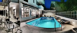 a swimming pool in the middle of a building at Erato Hotel in Agia Marina Aegina
