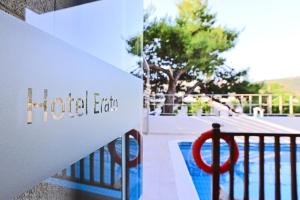 a hotel lax sign on a railing next to a pool at Erato Hotel in Agia Marina Aegina