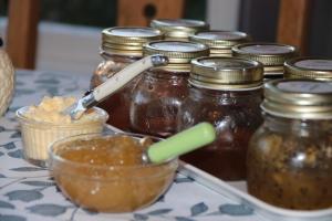 a table with jars of honey and a spoon in a bowl at The Point B&B in Kaikoura