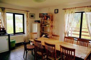 a kitchen with a large wooden table and chairs at MonteCrai in Şirnea
