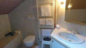 a white bathroom with a sink and a toilet at Furggerhof in Tirolo +27 photos