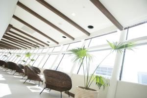 a row of chairs in a room with large windows at City Plaza Osaka in Osaka +62 photos