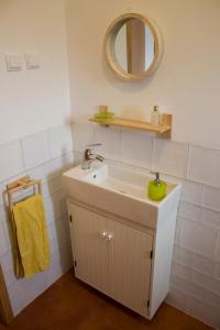 a bathroom with a sink and a mirror at Monte Quinta Verde in Ferreira do Alentejo