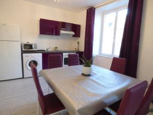 a kitchen and dining room with a table with chairs at Gite 7 km du Mont St Michel in Pontorson