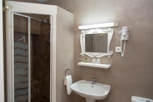 a bathroom with a sink and a mirror at Logis Hôtel La Farigoule in Sainte-Cécile-les-Vignes +39 photos