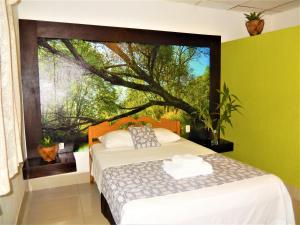 a bedroom with a bed and a large window at Hospedaje Neydita in Iquitos