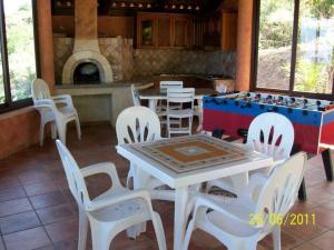 a dining room with a table and chairs and a fireplace at Agriturismo Brace in Santa Domenica