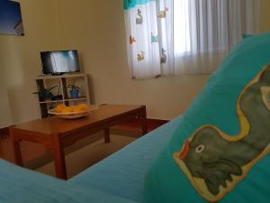 a bedroom with a table and a bowl of fruit on a bed at Casa Barroca in Carrapateira