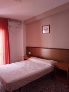 Postel nebo postele na pokoji v ubytování Hotel Iris