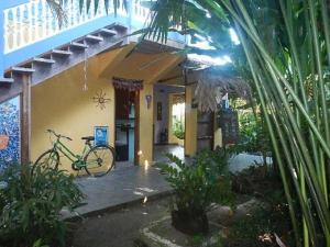 a bicycle is parked outside of a house at Cabinas Guarana in Puerto Viejo