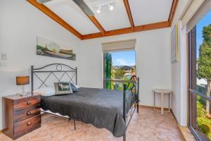 a bedroom with a bed and a window at Queensland South - Aldinga Beach - C21 SouthCoast Holidays in Aldinga Beach