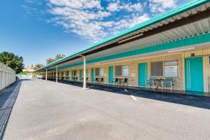 an empty building with tables and chairs on it at Coffs Harbour Pacific Palms Motel in Coffs Harbour