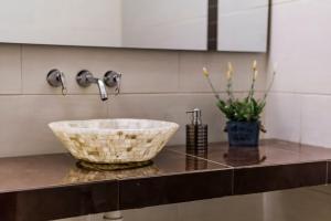 a bathroom counter with a sink and a bowl at Hotel El Giro in Villa de Leyva +196 photos