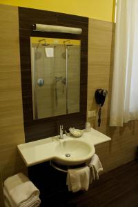 a bathroom with a sink and a mirror at Hotel Ambasciatori in Palermo