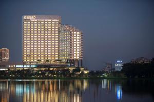 a lit up building in a city at night at Melia Yangon in Yangon
