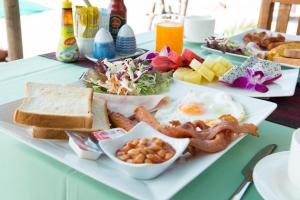 a plate of breakfast food on a table at Lamai Coconut Beach Resort in Lamai