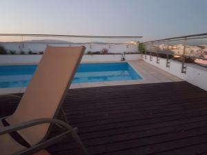 a swimming pool on the roof of a building at Alvor Ria Apartment in Alvor