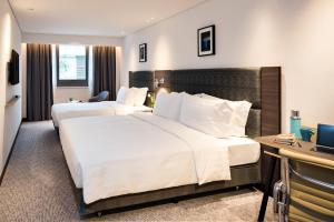 Letto o letti in una camera di Camlux Hotel