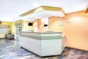 a lobby of a mitzpeel inn with a reception counter at Microtel Inn & Suites Newport News in Newport News