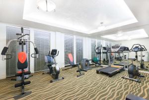 a gym with treadmills and ellipticals in a room at Hawthorn Extended Stay by Wyndham Richardson in Richardson
