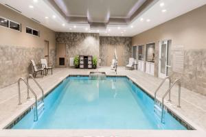 a swimming pool in a hotel lobby with a large pool at Microtel Inn & Suites by Wyndham - Penn Yan in Penn Yan