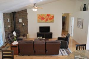 a living room with a couch and a tv at Big Tom's Cabin by Yosemite, lake and trails in Groveland