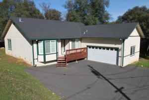 a small white garage with a bench in front of it at Big Tom's Cabin by Yosemite, lake and trails in Groveland