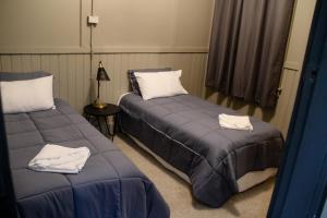 two beds in a room with a white bedspread at Bayview Hotel - Batemans Bay in Batemans Bay