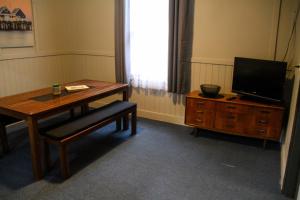 a living room with a desk and a chair at Bayview Hotel - Batemans Bay in Batemans Bay