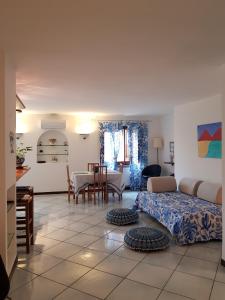 a living room with a bed and a table at La Casa Degli Ospiti in Naples