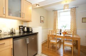 a kitchen with a table and a dining room at Avonlea Self-Catering in Crieff