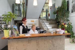 two women standing at a counter in a store at Hotel Don Bosco in Aschau am Inn