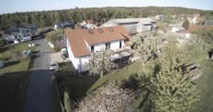 an overhead view of a house with a road and trees at Downstairs6b in Dipperz