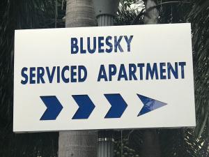 a sign on a pole that reads buses serviced appointment at Bluesky Serviced Apartment Airport Plaza in Ho Chi Minh City