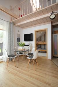 a living room with a dining room table and chairs at Apartament Makowe Pola in Żarnowska
