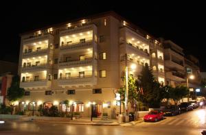 a city street at night with a large building at Elina Hotel Apartments in Rethymno Town