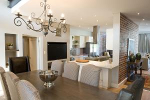 a dining room and kitchen with a table and chairs at 14 On Louw in Stellenbosch