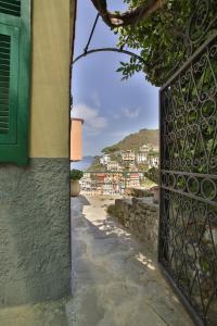 a gate to a house with a view of a street at 5 Terre For You in Riomaggiore