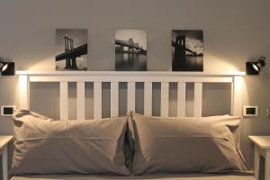 a bedroom with a bed with three pictures on the wall at Casa Mirò in Polignano a Mare