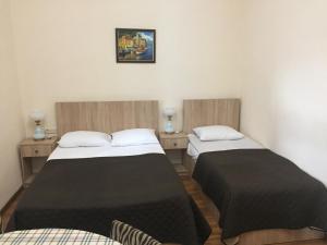 two beds in a small room with at R and B in Borjomi