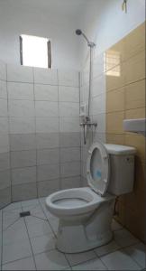 a bathroom with a toilet with the lid up at Calamba Pension Plaza in Calamba