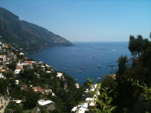 a view of a city with boats in the water at Hotel Posa Posa in Positano