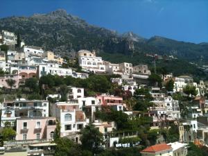 a bunch of white houses on a hill with a mountain at Hotel Posa Posa in Positano