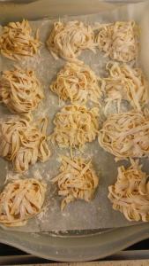 a pan filled with uncooked spaghetti on a table at Filoxenia in Nea Irakleia