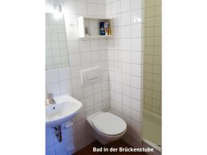 a bathroom with a toilet and a sink at Haus zur Eselsbrücke in Tangermünde +32 photos