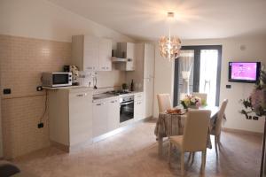 a kitchen and dining room with a table and a dining room at Amira Luxury Apartments in Santa Maria Capua Vetere